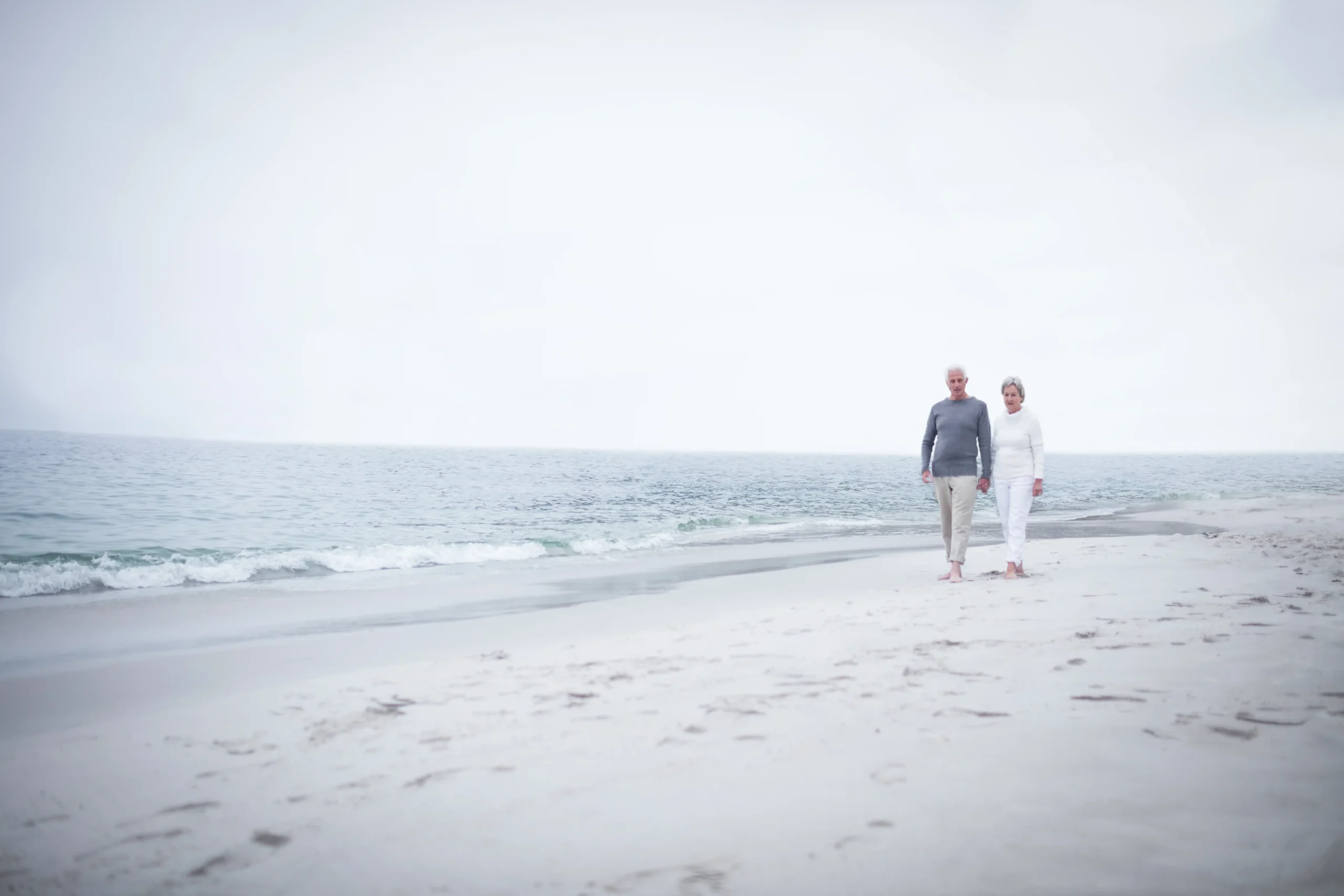 refractive lens exchange, clear lens extraction, older couple on beach